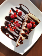 Cheesecake with chocolate and berries of raspberry and red currant