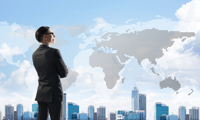 Concept of business success and control with confident boss against cityscape background