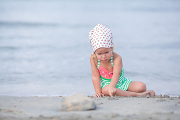 Little cute happy girl swims in the sea, Spain