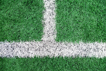 Green artificial grass football field. Half line in the middle of the football field. View from top...