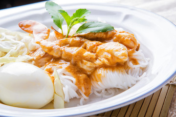 Rice noodle with crab sauce. Rice noodles with curry with crab, spices and coconut milk. Closeup view. © edkoumi