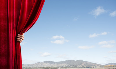 Summer natural bluesky view behind red velvet curtain