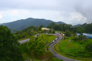 Fototapeta na wymiar Top view from Gunung Raya mountain to road and sportsman ready for running race, Langkawi island, Malaysia