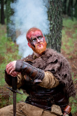 Obraz premium Bloody real viking with his sword training for combat