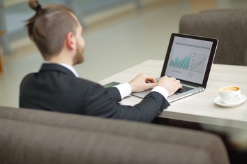 Businessman working on a laptop at office desk