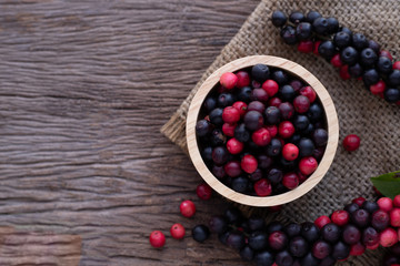 wood kitchen table with thai blueberries, traditional thai fruit.