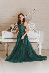 Woman in gorgeous green long evening chiffon dress, fashionable trend vintage chic for ladies 