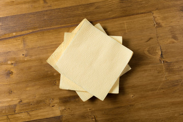 yellow paper napkin on wooden background