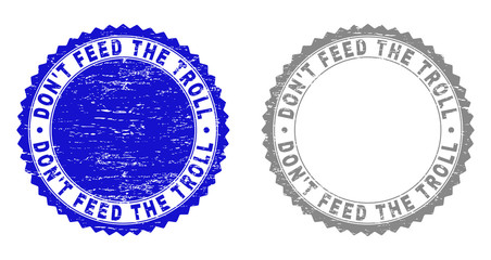 Grunge DON'T FEED THE TROLL stamp seals isolated on a white background. Rosette seals with distress texture in blue and grey colors.