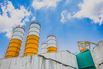 A concrete plant, also known as a batch plant or batching plant or a concrete batching plant. Large concrete plant on sunny days, beautiful, beautiful, fresh blue. Abstract blur.