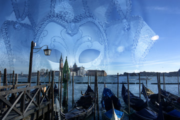Carnival in San Marco in Venice, with moored gondolas