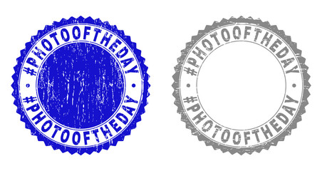 Grunge #PHOTOOFTHEDAY stamp seals isolated on a white background. Rosette seals with grunge texture in blue and grey colors. Vector rubber stamp imitation of #PHOTOOFTHEDAY label inside round rosette.