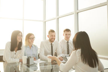 group of HR managers interview a young female candidate