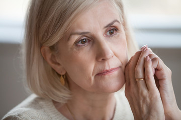 Close up portrait sad thoughtful attractive old woman