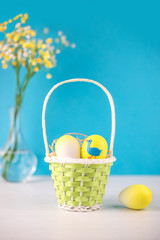Easter basket with eggs on white background.