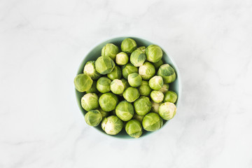 Bowl filled with Brussels Sprouts on White Marble