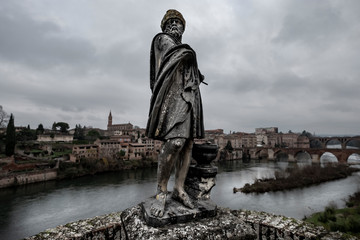 Sculpture in the gardens of the Berbie palace with the river Tarn in the background in the city of...