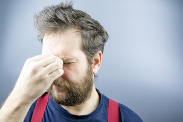 the man with the beard thought, the background gray suspenders red