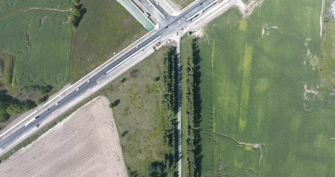 Top Down View Flying From Traffic Intersection To New Construction Neighborhood