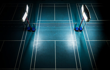 Indoor badminton court with bright white lights