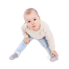 top view portrait of cute baby girl in winter clothes sitting isolated on white