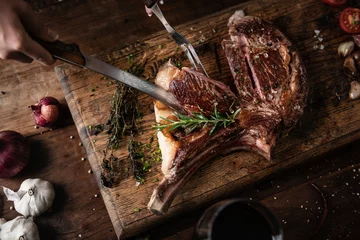 Foto op Plexiglas Tomahawk steak on a wooden board food photography recipe idea © Rawpixel.com