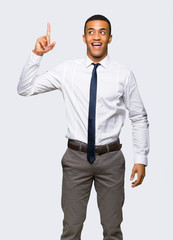 Young afro american businessman intending to realizes the solution while lifting a finger up on isolated background