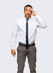 Young afro american businessman has just realized something and has intending the solution on isolated background