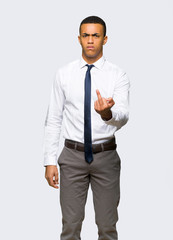 Young afro american businessman making horn gesture on isolated background