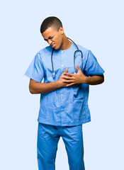 Surgeon doctor man having a pain in the heart on isolated background