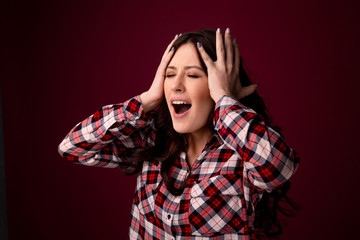 oung woman covering her eyes isolated on pink background