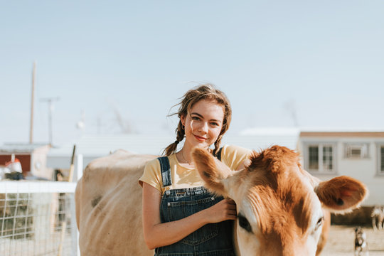 Happy woman with a cow