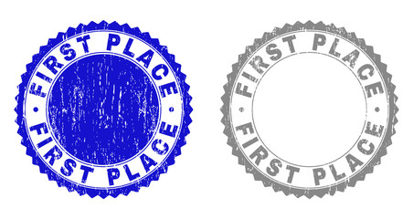 Grunge FIRST PLACE stamp seals isolated on a white background. Rosette seals with grunge texture in blue and grey colors. Vector rubber watermark of FIRST PLACE tag inside round rosette.