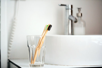 eco natural bamboo toothbrushes in glass. sustainable lifestyle concept. zero waste home. bathroom...