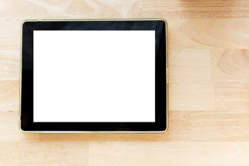 Top view background digital tablet with blank screen on wooden table.