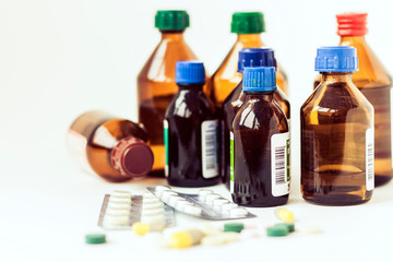 Medicine bottles, pills or capsules blister pack on white background with copy space for text, retro concept closeup.