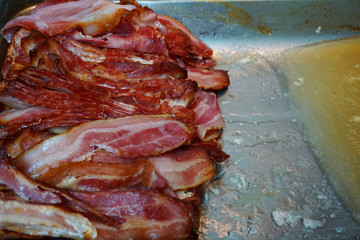 Delicious baked crispy bacon slices with pork belly fat and skin crispy  beautiful color close up unhealthy food 