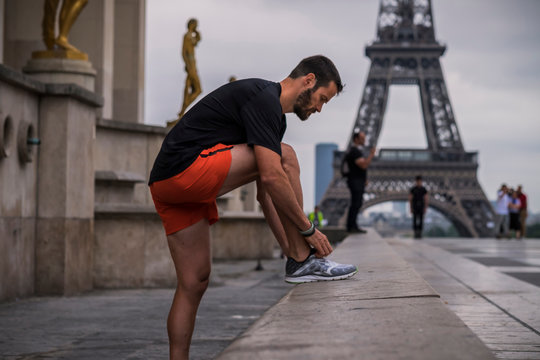 Man running in Paris near Louvre and Eiffel tower