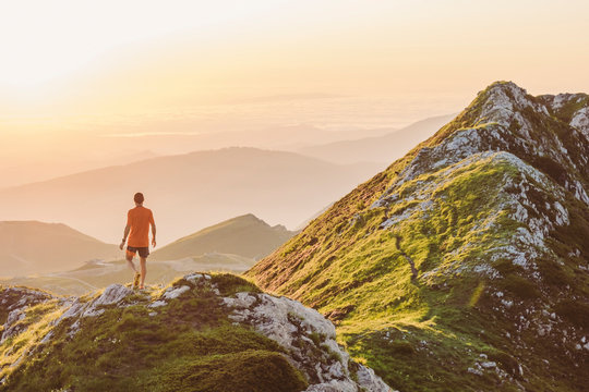 Man trail running on a mountain at the dask