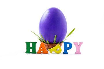 Big, violet, chicken egg in a small nest and happy word on white