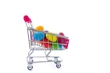 Colorful painted easter eggs in a shopping cart, seasonal sale concept on white