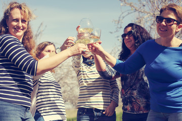 smiling real mature women is holding champagne glasses