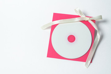 Fototapeta premium red envelope with yellow ribbon in the shape of a bow for CD, vertical position . square envelope