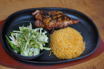 Filipino chicken thigh adobo barbecue with yellow rice and cabbage salad  traditional food Asian cuisine 