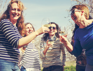 smiling real mature women is holding champagne glasses