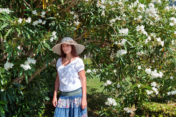 Girl next to a bush with white flowers. Budva, Montenegro