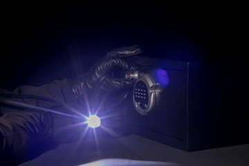 a thief stealing digital data from black gloves safes