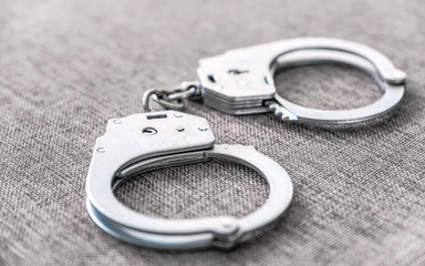 The cuffs on the table. Police unit. Close-up top view selective focus.