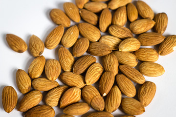 handful of almonds on white background