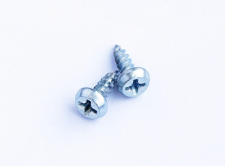 Two steel screws on white background